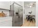 Kitchen with stainless steel refrigerator and view into dining area at 14652 E 2Nd Ave # 202D, Aurora, CO 80011