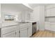 Kitchen with white cabinets, marble countertops, and stainless steel dishwasher at 14652 E 2Nd Ave # 202D, Aurora, CO 80011