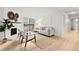 Living room features hardwood floors, fireplace, and access to balcony at 14652 E 2Nd Ave # 202D, Aurora, CO 80011