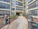 Exterior entry to a condominium, nicely landscaped with shrubs and festive holiday decorations at 13961 E Marina Dr # 205, Aurora, CO 80014