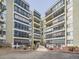 Multi-story apartment building with balconies, large windows, and landscaped entrance showcasing modern architecture at 13961 E Marina Dr # 205, Aurora, CO 80014