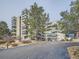 Exterior view of condo building featuring multiple balconies and mature trees in the landscape at 13961 E Marina Dr # 205, Aurora, CO 80014