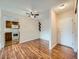Bright living room featuring wood floors, ceiling fan, and access to a kitchen with modern appliances at 13961 E Marina Dr # 205, Aurora, CO 80014