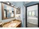 Bathroom with granite countertop, vanity, and direct access to the bedroom at 7780 W 38Th Ave # 203, Wheat Ridge, CO 80033