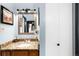 Elegant bathroom with granite countertop vanity, framed mirror, and soft lighting at 7780 W 38Th Ave # 203, Wheat Ridge, CO 80033