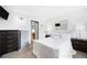 Bright bedroom with dark wood dresser, mirrored closet, and ensuite bathroom access at 7780 W 38Th Ave # 203, Wheat Ridge, CO 80033