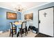 Bright dining room with table and seating, stylish light fixture, and tiled floor at 7780 W 38Th Ave # 203, Wheat Ridge, CO 80033