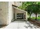 Building entrance featuring glass doors, stone facade, benches, and landscaping at 7780 W 38Th Ave # 203, Wheat Ridge, CO 80033