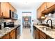 Kitchen view of stainless steel appliances, granite countertops, tile backsplash, and dining room view at 7780 W 38Th Ave # 203, Wheat Ridge, CO 80033