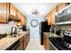 Kitchen with stainless steel appliances, tile backsplash, and granite countertops at 7780 W 38Th Ave # 203, Wheat Ridge, CO 80033