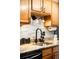 Kitchen featuring granite countertops, stainless steel appliances, tile backsplash, updated lighting, and a sink at 7780 W 38Th Ave # 203, Wheat Ridge, CO 80033