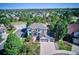 An aerial view of a beautiful home nestled in a lush, green neighborhood at 327 Ingleton Ct, Castle Pines, CO 80108
