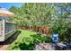 Private backyard area with lush greenery, mature trees, stone patio, and a fire pit at 327 Ingleton Ct, Castle Pines, CO 80108