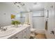 A bright bathroom features a double sink vanity, a soaking tub, and a shower at 327 Ingleton Ct, Castle Pines, CO 80108