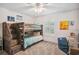 A bedroom features bunk beds, carpet floors, neutral colored walls, and a ceiling fan at 327 Ingleton Ct, Castle Pines, CO 80108