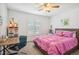 This bright bedroom features carpet flooring, neutral colored walls, and a ceiling fan at 327 Ingleton Ct, Castle Pines, CO 80108
