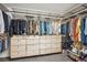 This closet boasts custom cabinets and hanging racks for optimal storage and organization at 327 Ingleton Ct, Castle Pines, CO 80108