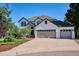 Stunning two-story home featuring a three-car garage and a well-manicured front yard at 327 Ingleton Ct, Castle Pines, CO 80108