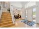 Welcoming foyer with hardwood floors and staircase, leading to the dining area at 327 Ingleton Ct, Castle Pines, CO 80108