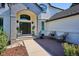 Inviting front porch with brick accents, seating area, and elegant entryway at 327 Ingleton Ct, Castle Pines, CO 80108