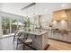 Bright kitchen with a large marble island, modern appliances, and an open patio view at 327 Ingleton Ct, Castle Pines, CO 80108
