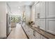 Modern kitchen with white cabinetry, stainless steel appliances, and a long countertop at 327 Ingleton Ct, Castle Pines, CO 80108