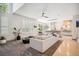 Bright and airy living room featuring an open floor plan, modern ceiling fan, and access to the kitchen at 327 Ingleton Ct, Castle Pines, CO 80108