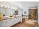 A bathroom features double sinks, a soaking tub, and a shower with tile walls at 327 Ingleton Ct, Castle Pines, CO 80108
