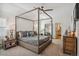 Spacious main bedroom features a four-poster bed and ensuite access at 327 Ingleton Ct, Castle Pines, CO 80108
