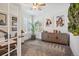 Office space with wooden desk, a large potted plant, and shuttered windows at 327 Ingleton Ct, Castle Pines, CO 80108