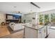Bright, open concept kitchen and living area with a modern fireplace and natural light at 327 Ingleton Ct, Castle Pines, CO 80108