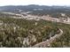 Aerial view of house and neighborhood in the mountains at 7845 Armadillo Trl, Evergreen, CO 80439