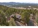 Stunning aerial view of a secluded home surrounded by lush forests and mountain views at 7845 Armadillo Trl, Evergreen, CO 80439