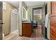 Well-lit bathroom with glass-enclosed shower and modern vanity at 7845 Armadillo Trl, Evergreen, CO 80439