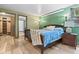 Comfortable bedroom features an attached bathroom, wood floors, and natural light at 7845 Armadillo Trl, Evergreen, CO 80439