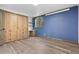 Bedroom with custom built-ins, desk, and wood floors at 7845 Armadillo Trl, Evergreen, CO 80439
