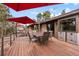 Outdoor deck with patio furniture and red umbrella at 7845 Armadillo Trl, Evergreen, CO 80439