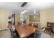 Well-appointed dining area with a large table, decorative lighting, and a view to the kitchen at 7845 Armadillo Trl, Evergreen, CO 80439