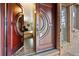 Elegant entryway features a unique front door and brick flooring at 7845 Armadillo Trl, Evergreen, CO 80439