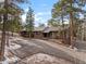 Brick house exterior with driveway and landscaping at 7845 Armadillo Trl, Evergreen, CO 80439
