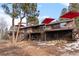 Brick house exterior with large deck and mountain views at 7845 Armadillo Trl, Evergreen, CO 80439