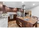 Gourmet kitchen boasts stainless steel appliances, custom cabinets, and center island at 7845 Armadillo Trl, Evergreen, CO 80439