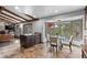 Bright kitchen eating area with beamed ceiling and views of the surrounding landscape at 7845 Armadillo Trl, Evergreen, CO 80439