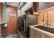 Well-organized laundry room with modern washer/dryer and custom built-in cabinets at 7845 Armadillo Trl, Evergreen, CO 80439