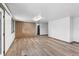 Spacious living room featuring wood-style flooring and ample natural light with neutral paint at 7845 Armadillo Trl, Evergreen, CO 80439