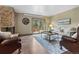 Cozy living room features a stone fireplace and sliding glass doors to the deck at 7845 Armadillo Trl, Evergreen, CO 80439