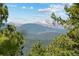 Scenic mountain landscape framed by lush green trees, creating a serene and picturesque view at 7845 Armadillo Trl, Evergreen, CO 80439