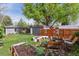 Lush backyard featuring a fire pit, vegetable garden, shed and outdoor seating area at 1343 Gay St, Longmont, CO 80501