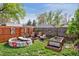 Fenced backyard oasis with a fire pit, custom raised garden beds, and cozy seating at 1343 Gay St, Longmont, CO 80501