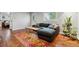 Bright living room featuring hardwood floors, a comfortable sofa, and stylish rug at 1343 Gay St, Longmont, CO 80501